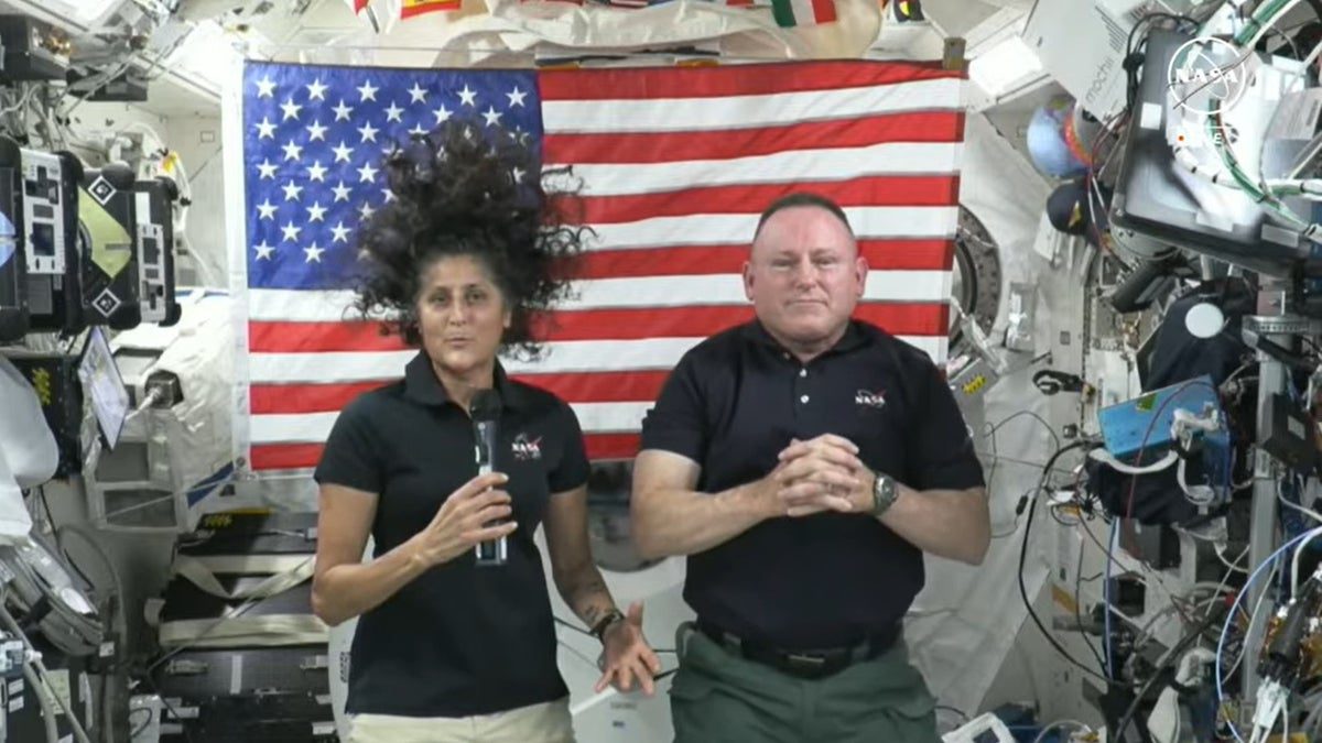 Os astronautas da NASA Sonny Williams e Butch Wilmore nadam dentro de uma espaçonave